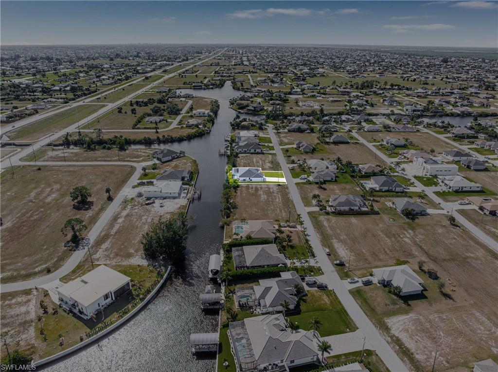 Aerial overview of property's location with nearby suburban area and a large body of water