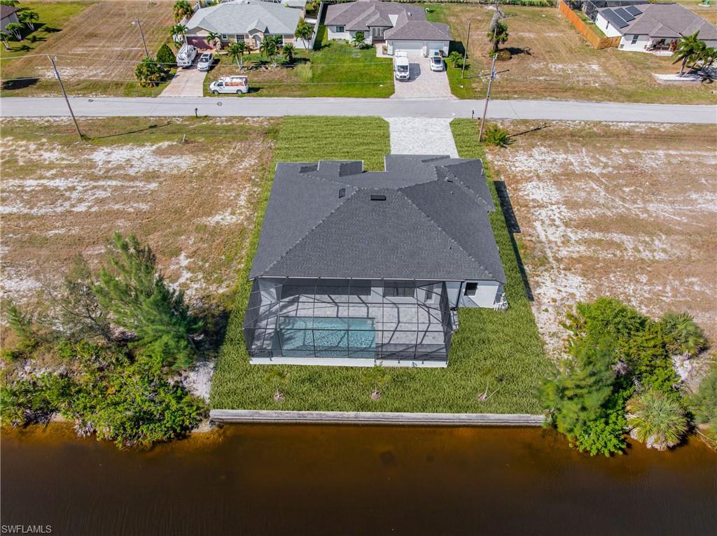 Aerial perspective of suburban area featuring a nearby body of water