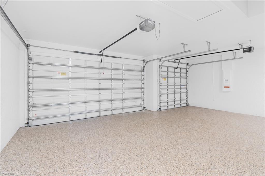 Garage with a garage door opener and electric panel