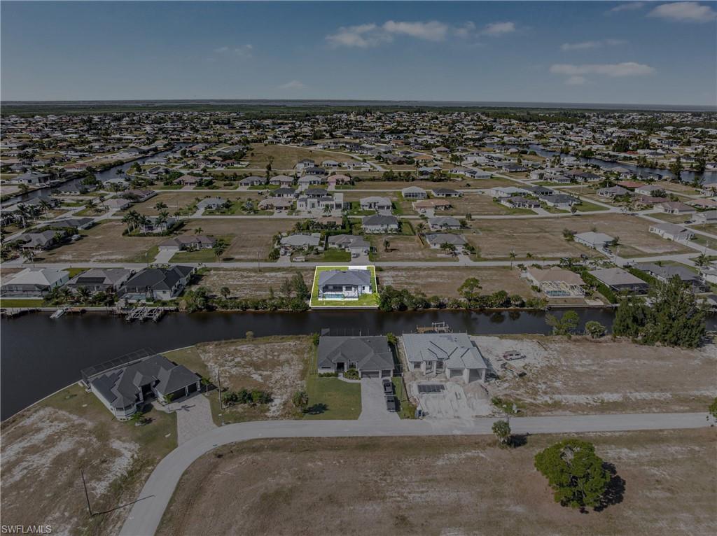Aerial view of property's location with nearby suburban area and a large body of water