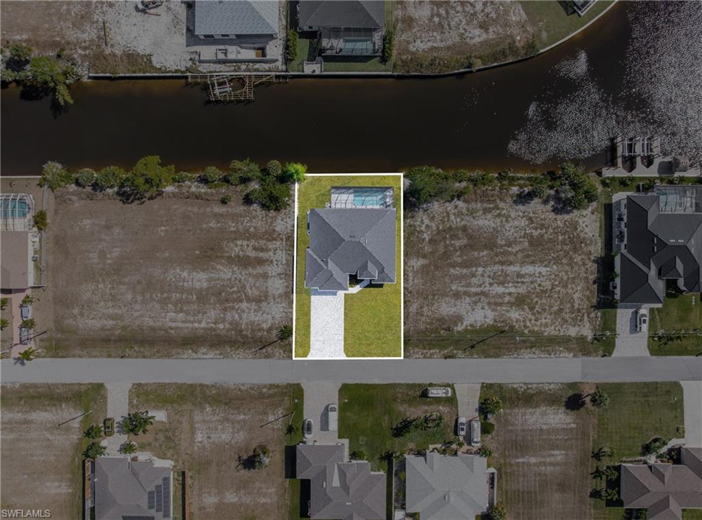 Aerial overview of property's location with a nearby body of water and nearby suburban area