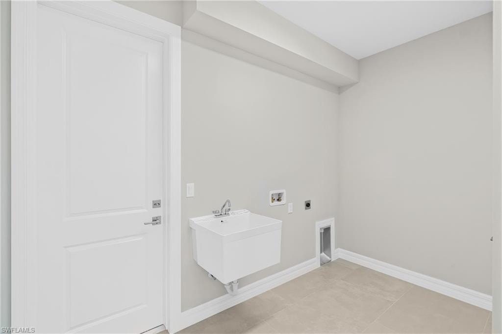Laundry room featuring hookup for an electric dryer, washer hookup, and light tile patterned flooring