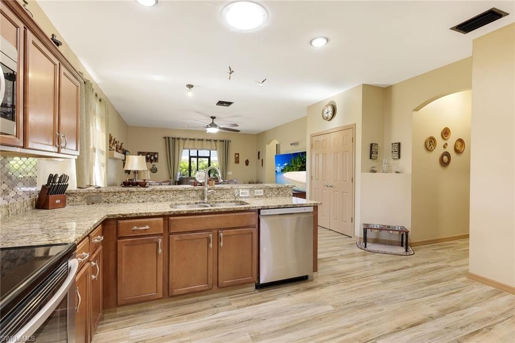 Bedroom with light wood-style flooring and a ceiling fan
