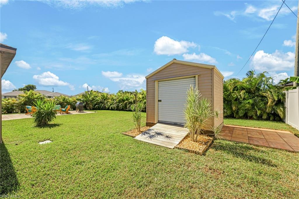 View of property exterior with stucco siding and a lawn