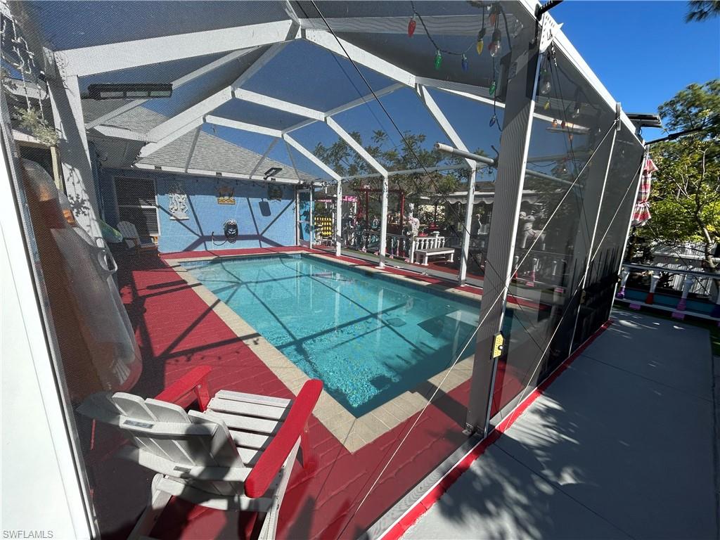 Outdoor pool with a lanai and a sunroom