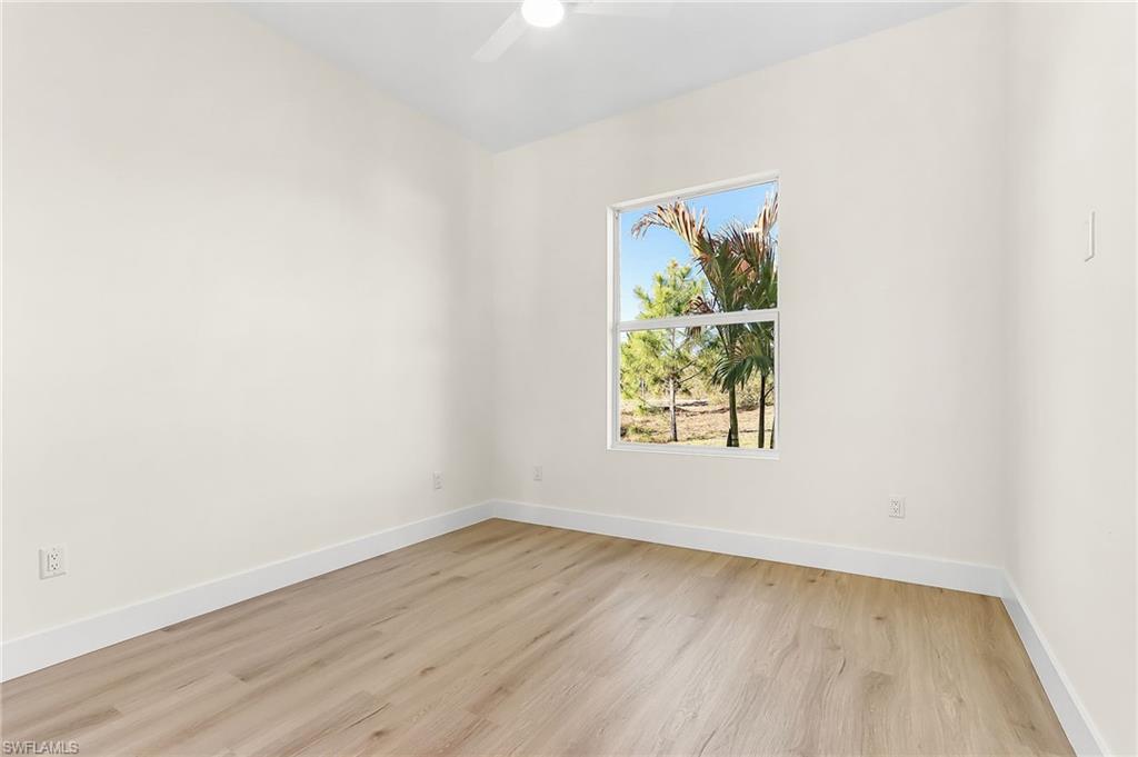 Spare room with light wood-style floors and ceiling fan