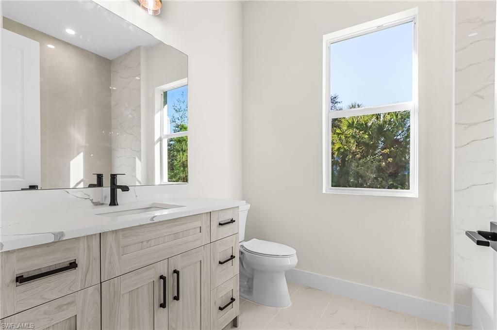 Full bath featuring vanity and toilet