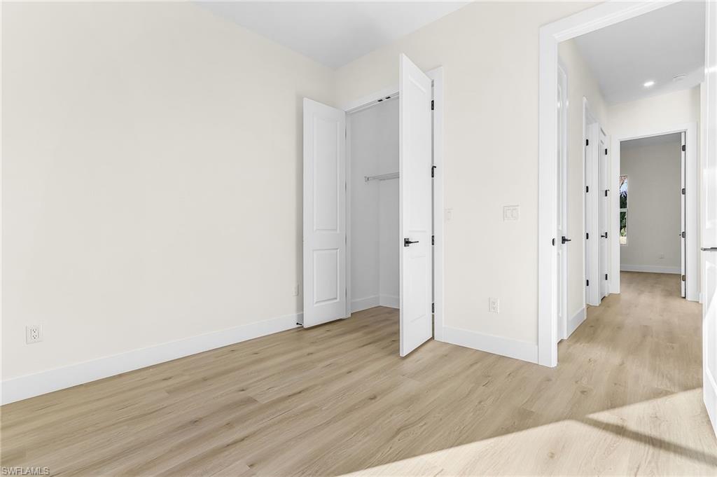 Unfurnished bedroom featuring light wood-type flooring and a closet
