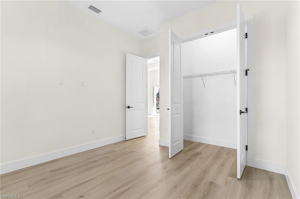 Unfurnished bedroom with a closet and light wood-style floors