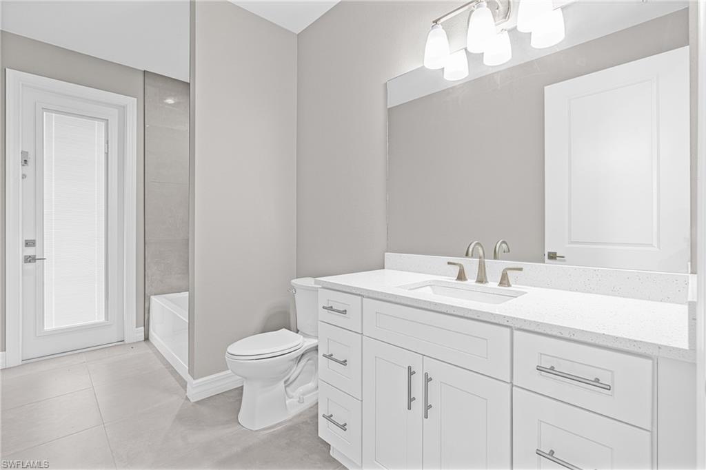 Bathroom with vanity and light tile patterned floors
