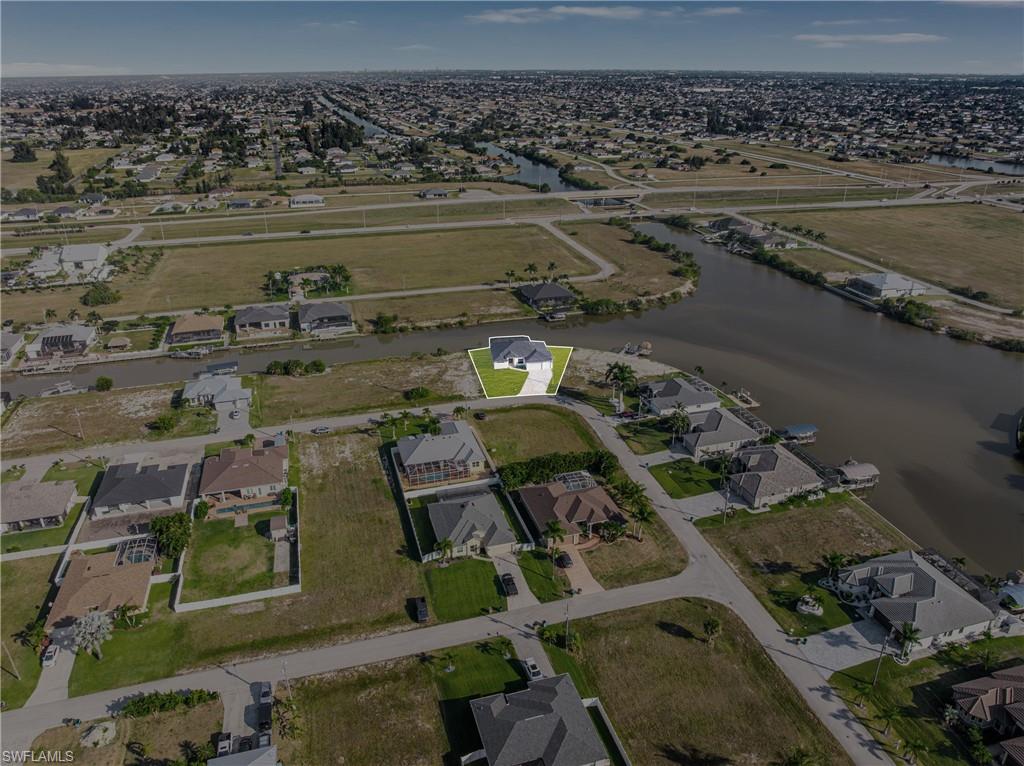 Aerial view of property's location with nearby suburban area and a large body of water