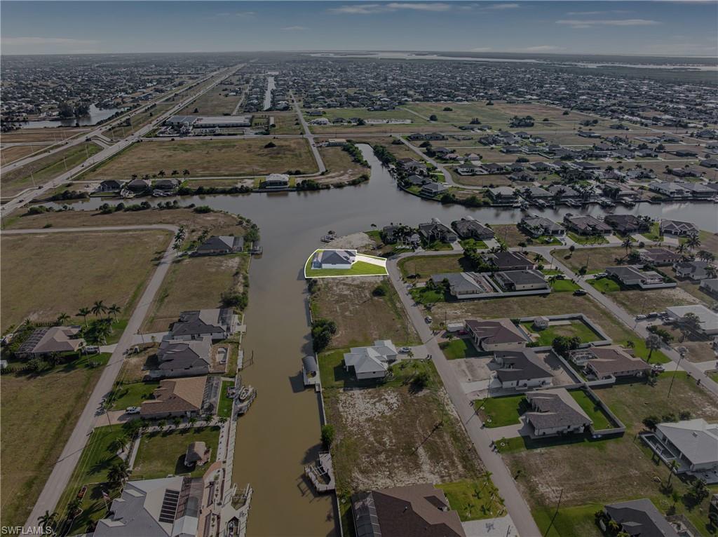 Aerial view of property's location featuring nearby suburban area and a large body of water