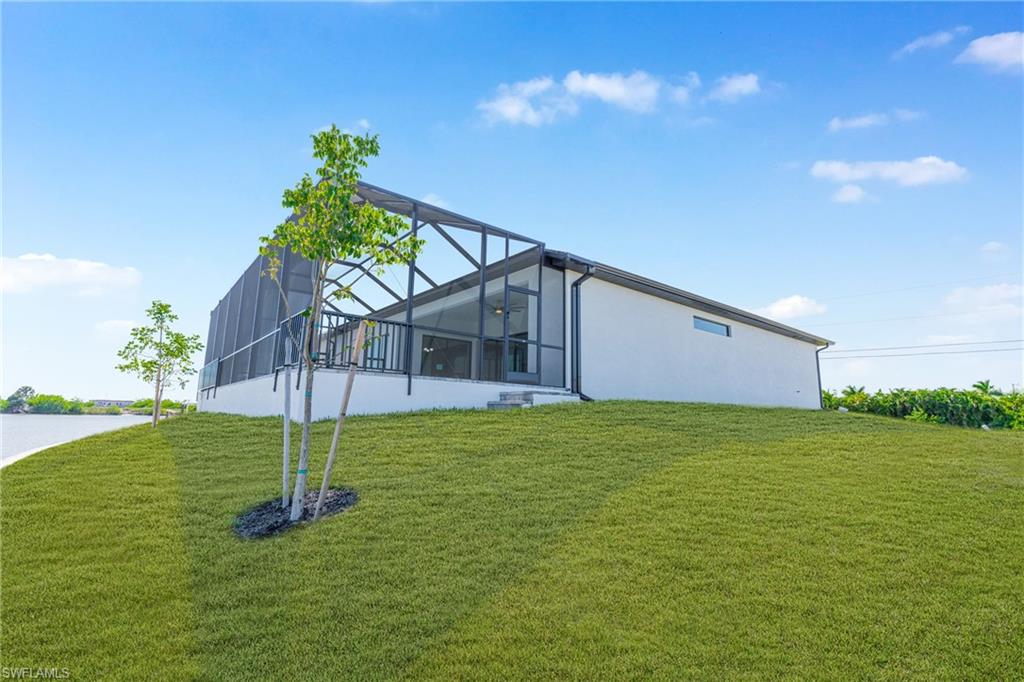View of property exterior with a yard, a lanai, a sunroom, and a patio