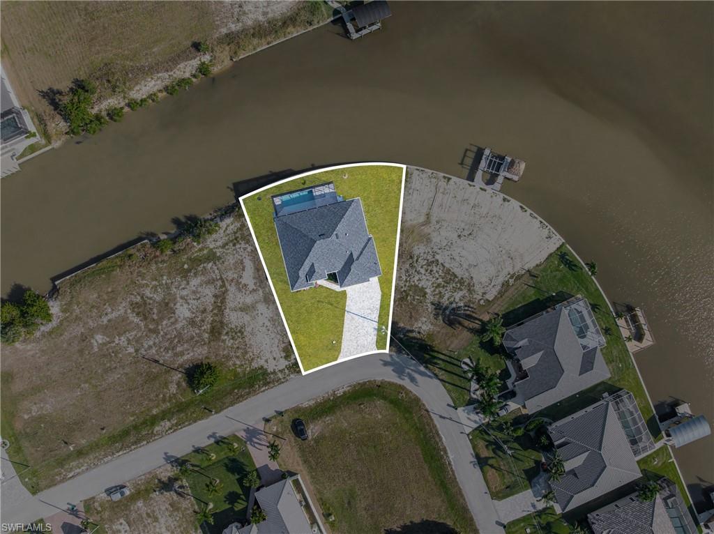 Aerial view of property's location featuring a nearby body of water and property boundaries highlighted