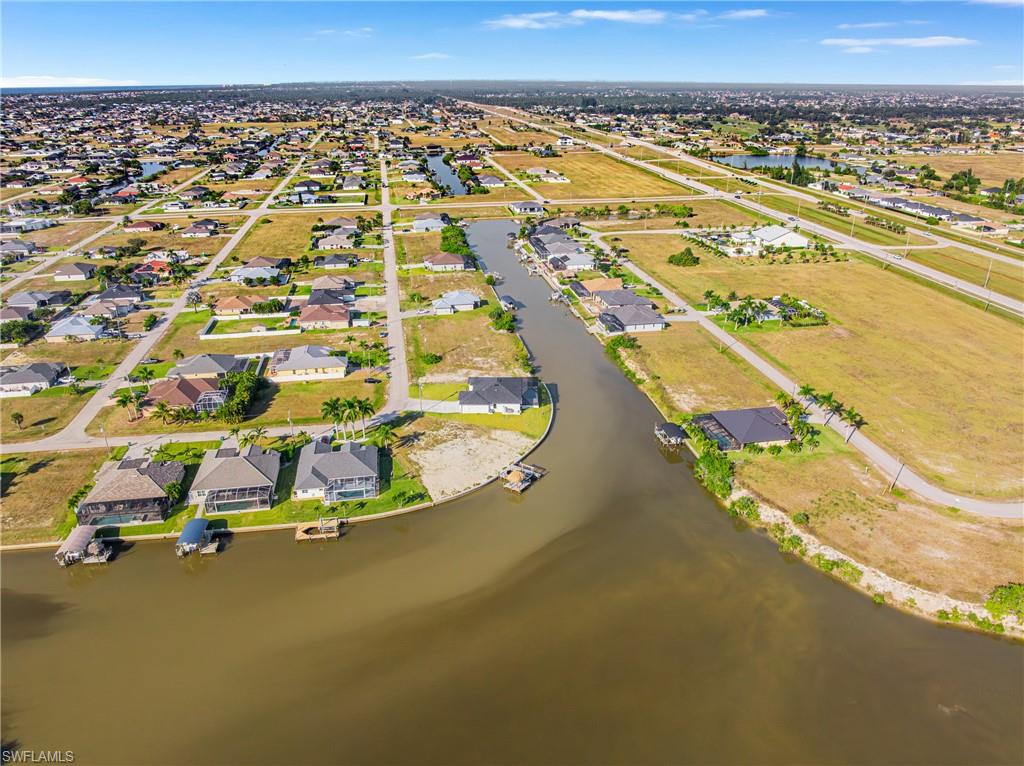 Aerial perspective of suburban area featuring a large body of water