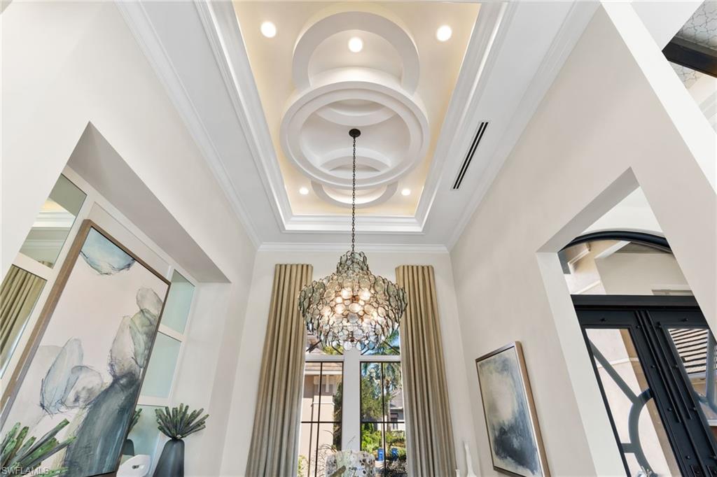 Detailed view of custom ceiling, hanging lights, and ornamental molding