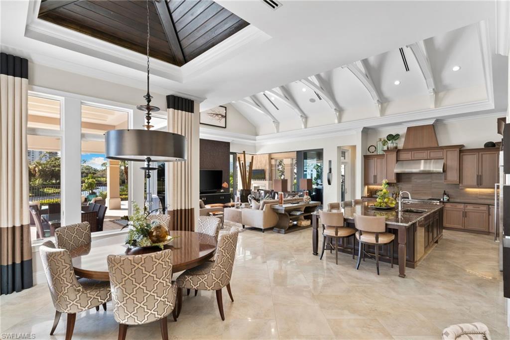 Dining space featuring ornamental molding and lofted ceiling