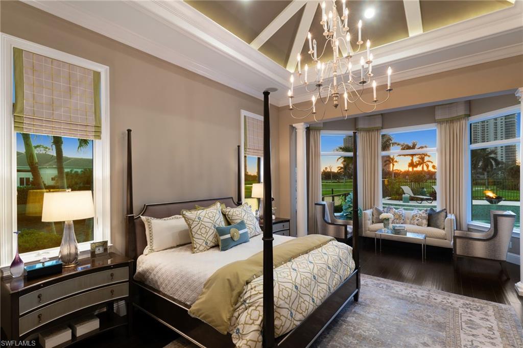 Bedroom with crown molding, hardwood / wood-style floors, and hanging lights