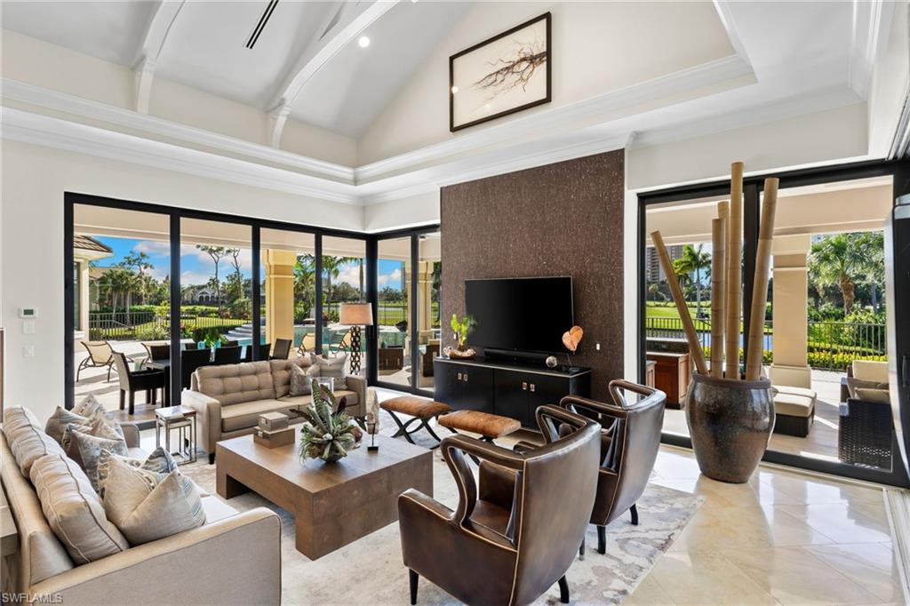 Living room featuring vaulted ceiling and recessed lighting