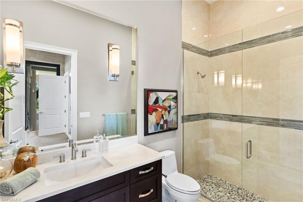 Bathroom featuring a shower stall and vanity
