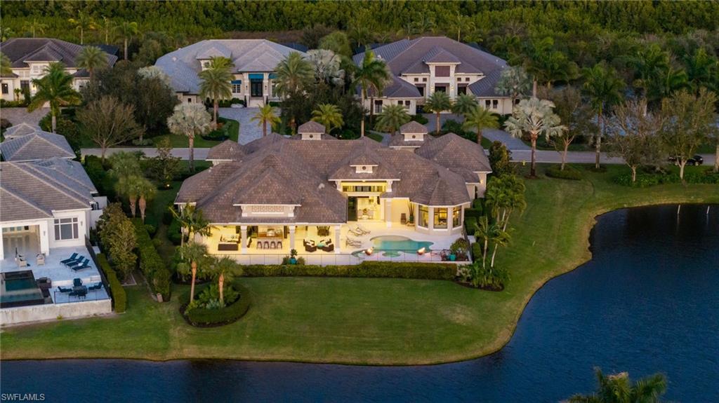 Bird's eye view of a nearby body of water and a pool