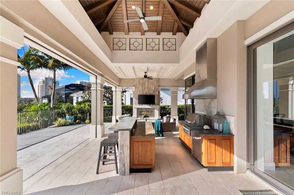 View of patio featuring ceiling fan and exterior kitchen