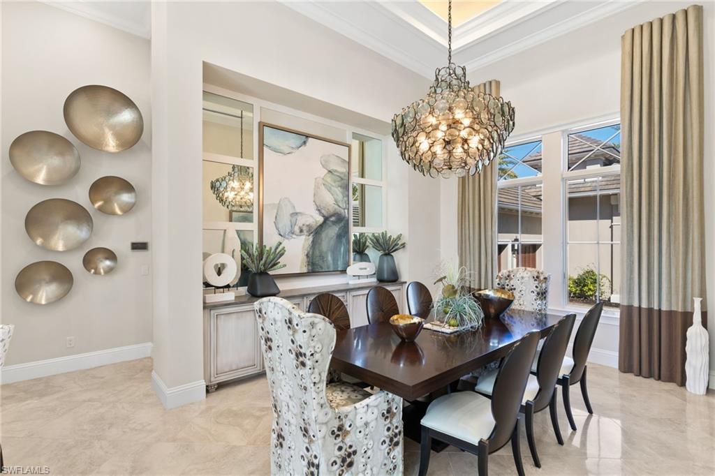 Dining space with crown molding and hanging lights