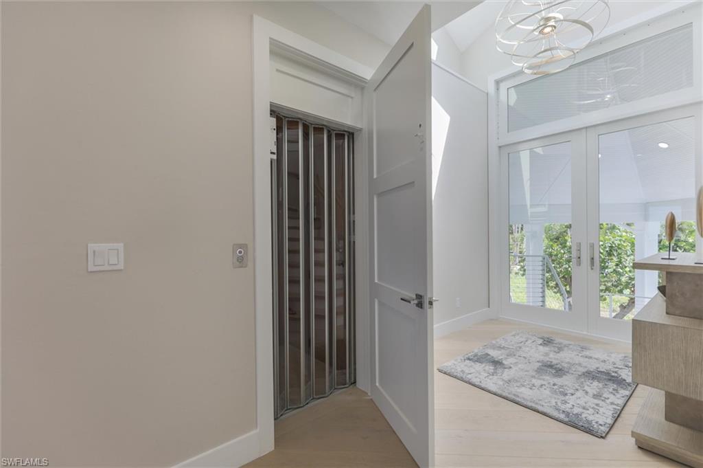 Bathroom featuring hardwood / wood-style floors and french doors