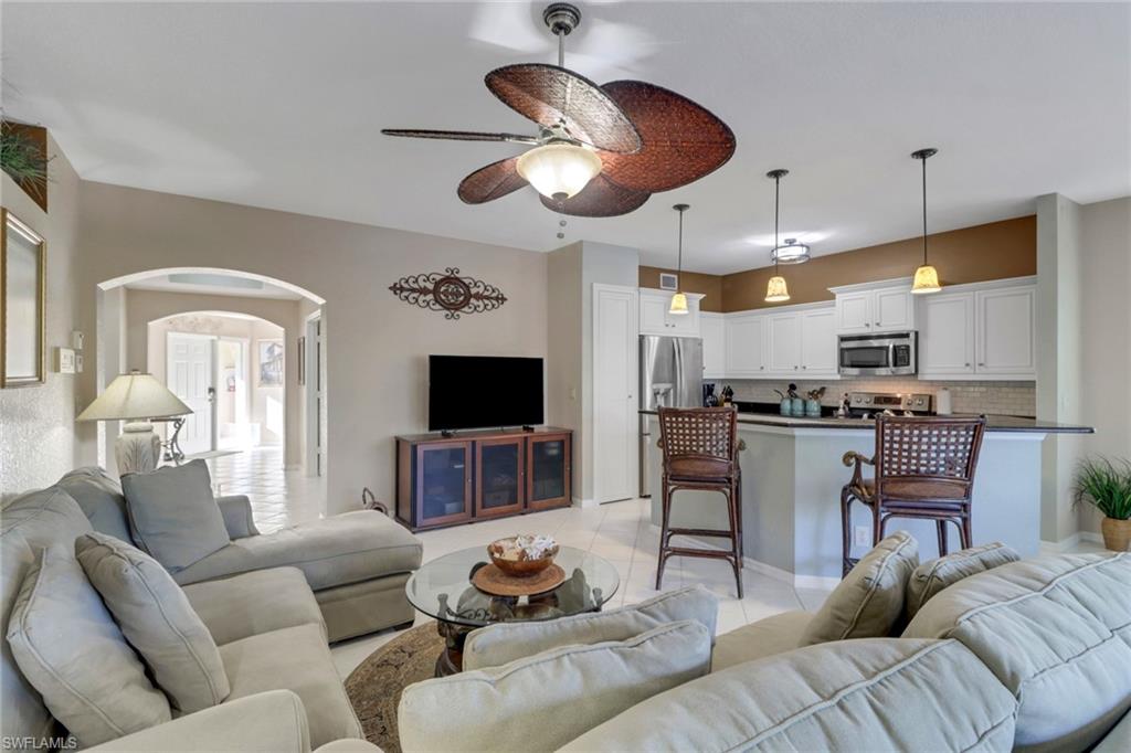 Living room featuring ceiling fan and light tile patterned flooring