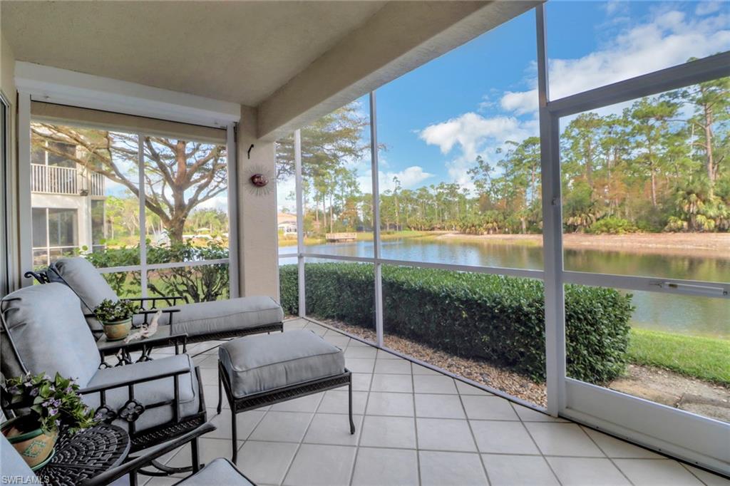 Sunroom featuring a water view