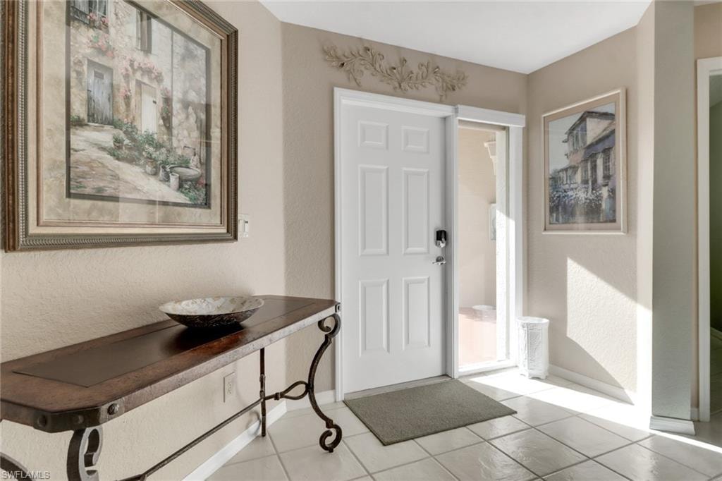 Entryway with light tile patterned floors