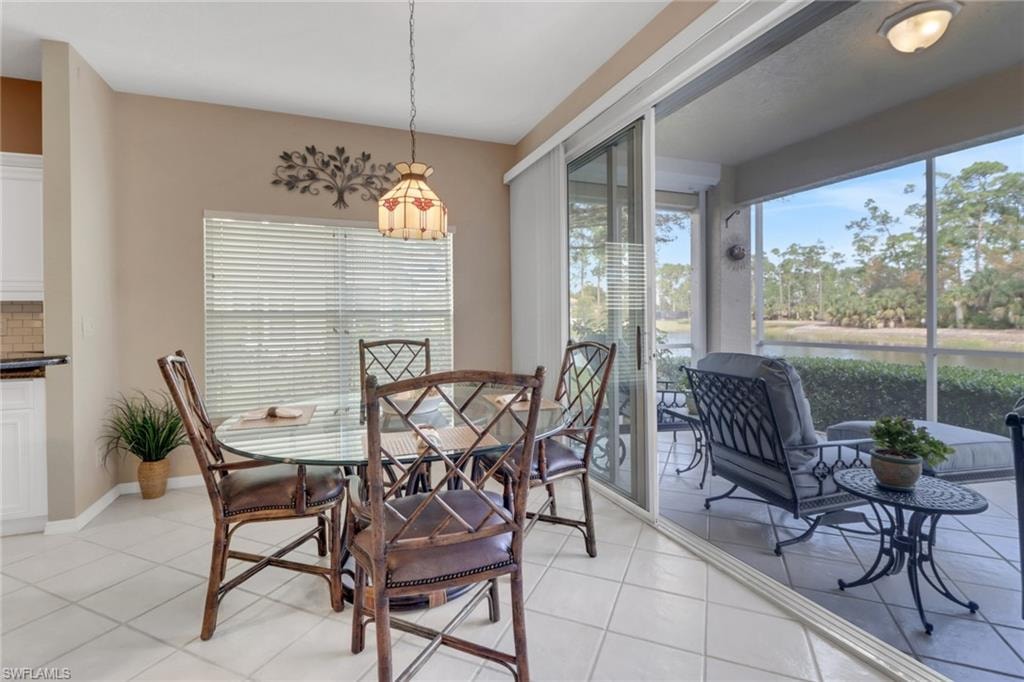 Dining area with light tile patterned flooring