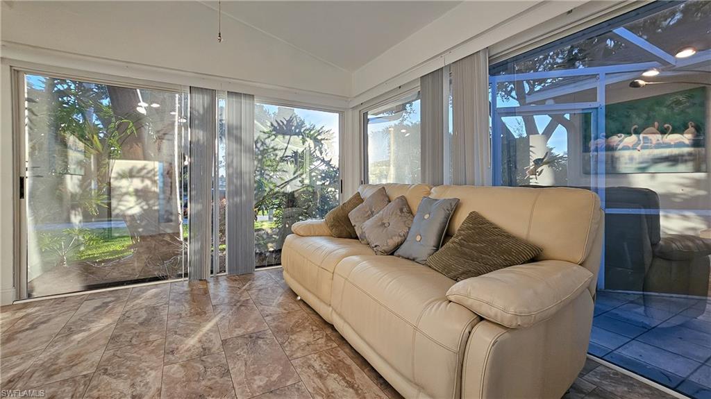 Sunroom featuring lofted ceiling