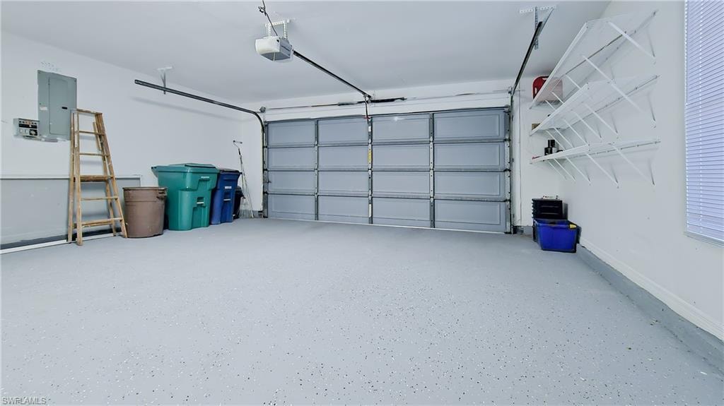 Garage with electric panel and a garage door opener