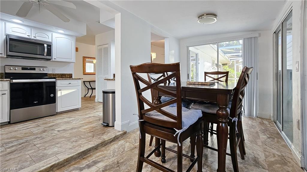 Dining room with baseboards and a ceiling fan