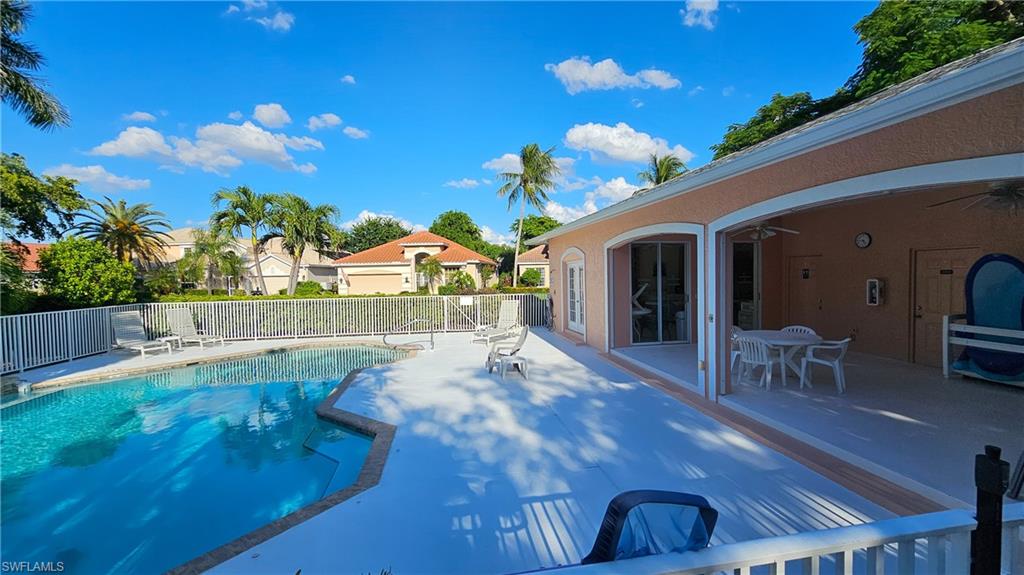 View of pool featuring a ceiling fan, a patio, a residential view, and outdoor dining space
