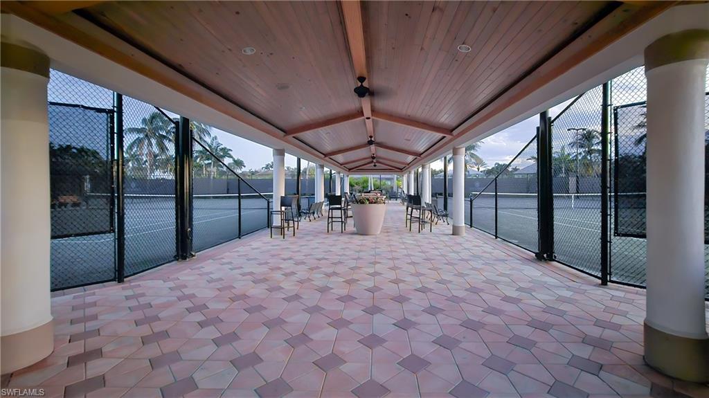 Sunroom featuring a patio area and beam ceiling