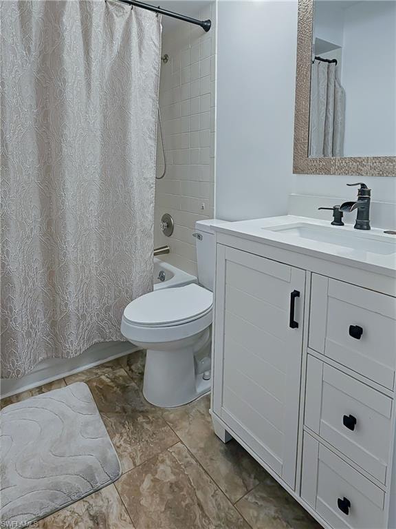 Full bath with vanity, shower / bath combo, and light tile patterned floors