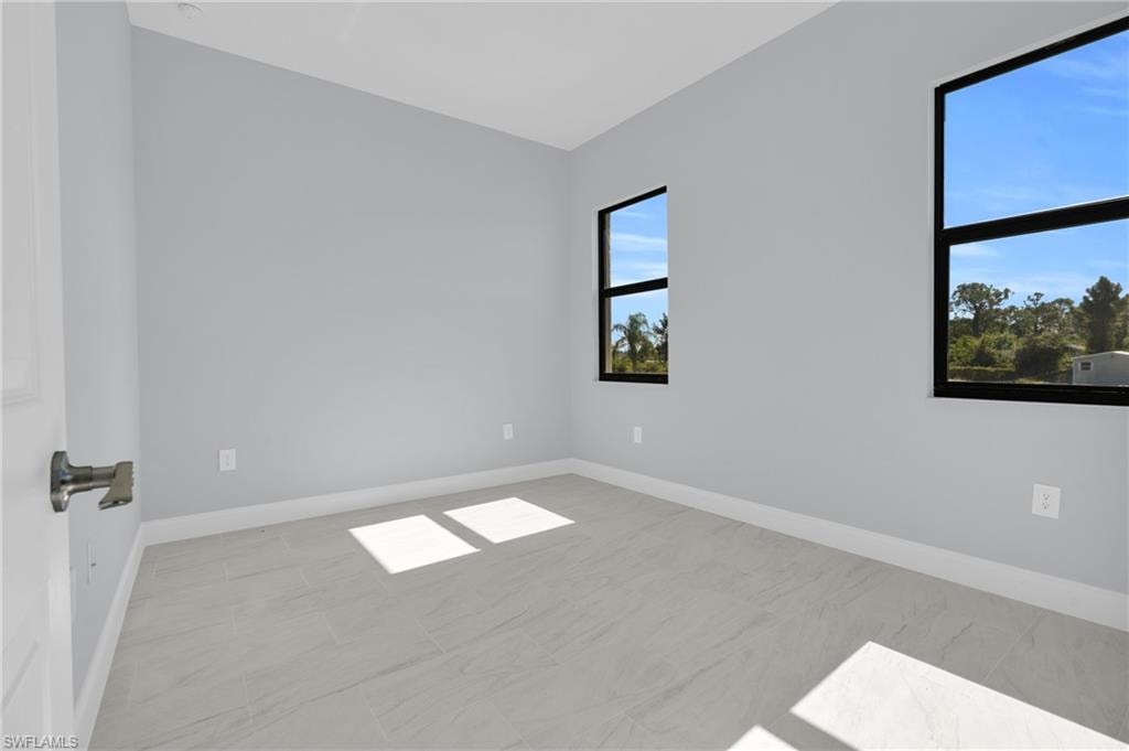 Spare room featuring baseboards