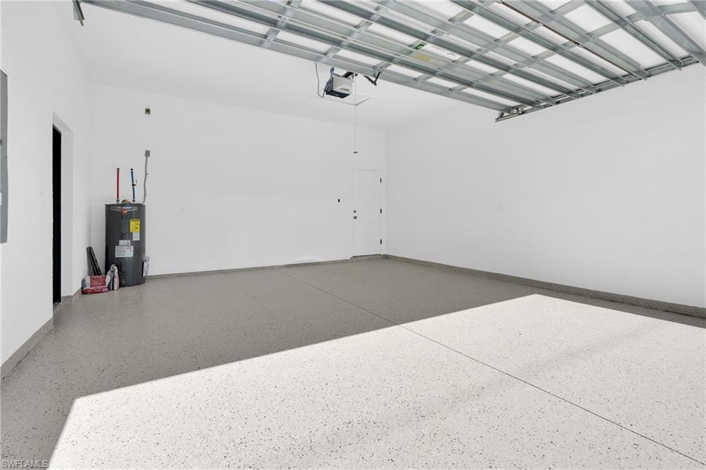 Garage with electric water heater and a garage door opener