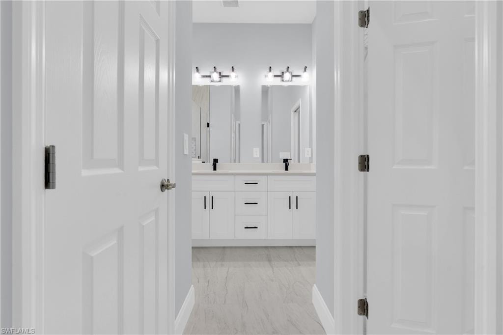 Full bath featuring double vanity