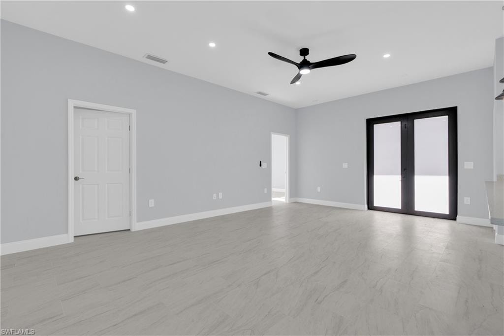Spare room with recessed lighting, ceiling fan, and french doors