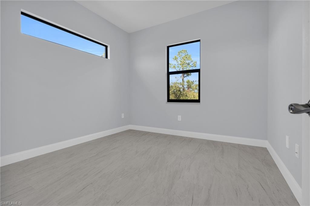 Unfurnished room featuring baseboards