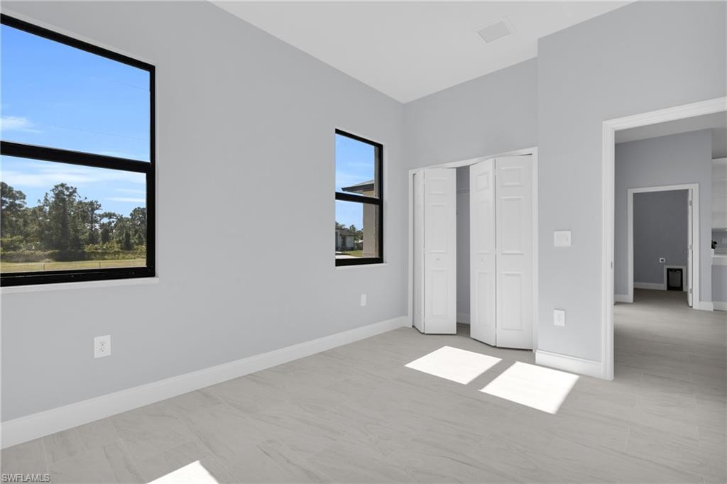 Unfurnished bedroom with baseboards and a closet