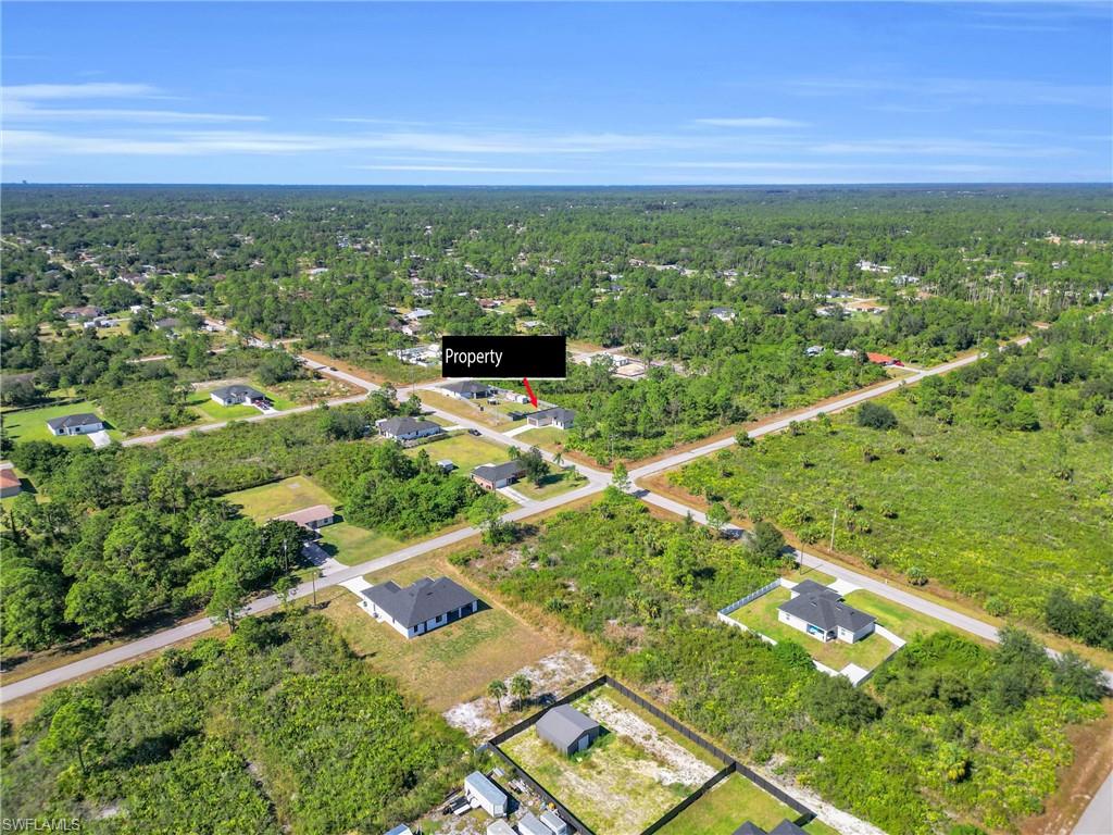 Aerial overview of property's location featuring a heavily wooded area and nearby suburban area