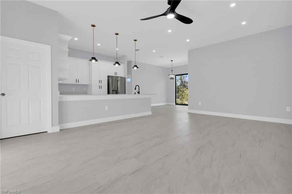 Unfurnished living room featuring recessed lighting and ceiling fan