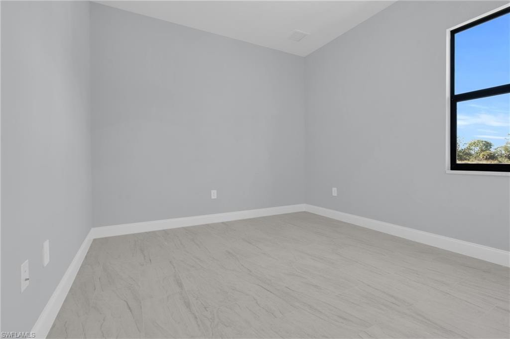Spare room featuring baseboards