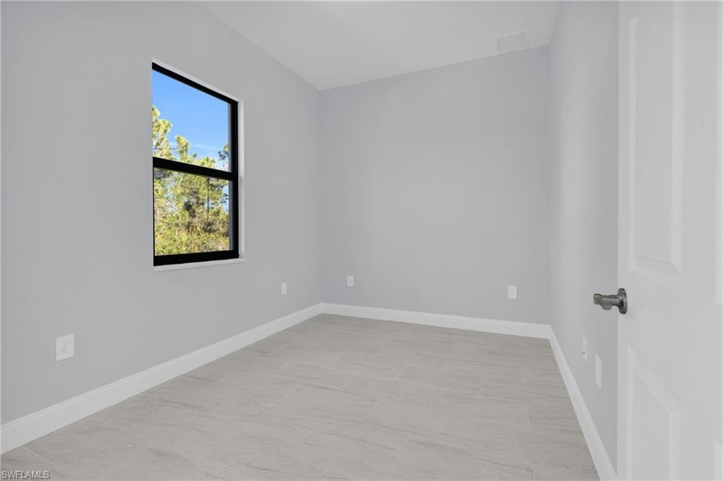 Empty room featuring baseboards