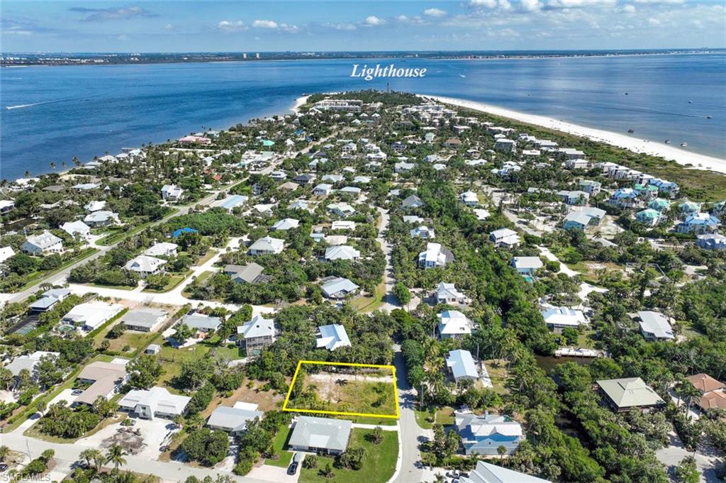 Aerial overview of property's location with property parcel outlined and nearby suburban area