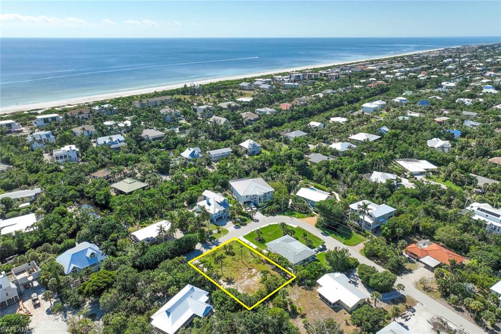 Aerial perspective of suburban area with expansive coastline and property boundaries highlighted